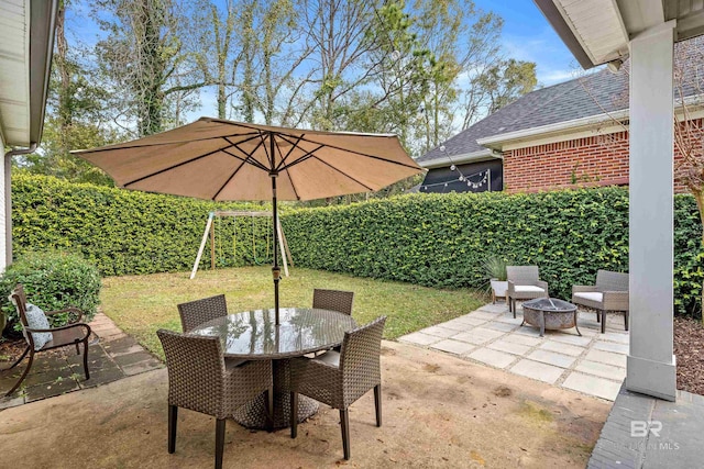 view of patio / terrace featuring an outdoor fire pit