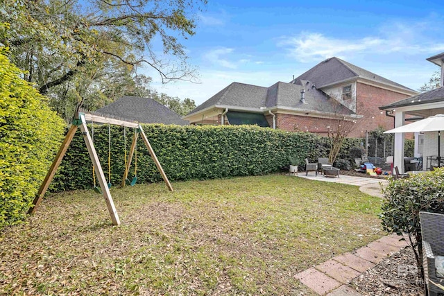 view of yard featuring a playground and a patio area