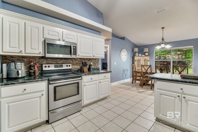 10675 Aloe Ln, Lillian, AL 36549 - kitchen featuring stainless steel appliances, vaulted ceiling, tasteful backsplash, light tile patterned floors, and pendant lighting