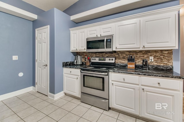 10675 Aloe Ln, Lillian, AL 36549 - kitchen featuring stainless steel appliances, backsplash, baseboards, light tile patterned flooring, and white cabinets