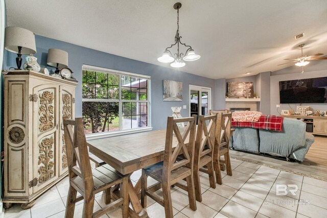 10675 Aloe Ln, Lillian, AL 36549 - dining room with light tile patterned floors, a chandelier, and a ceiling fan