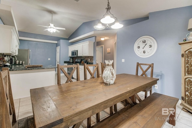 10675 Aloe Ln, Lillian, AL 36549 - dining area featuring a ceiling fan, light tile patterned flooring, and vaulted ceiling