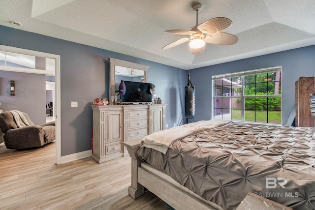 10675 Aloe Ln, Lillian, AL 36549 - bedroom with light wood-style floors, a textured ceiling, baseboards, and a ceiling fan