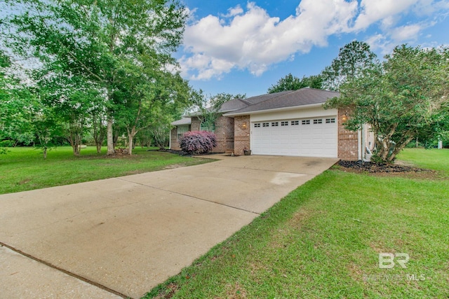 10675 Aloe Ln, Lillian, AL 36549 - view of front of house featuring brick siding, an attached garage, concrete driveway, and a front yard