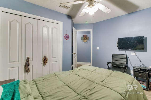 10675 Aloe Ln, Lillian, AL 36549 - bedroom featuring a closet, a ceiling fan, wood finished floors, and baseboards