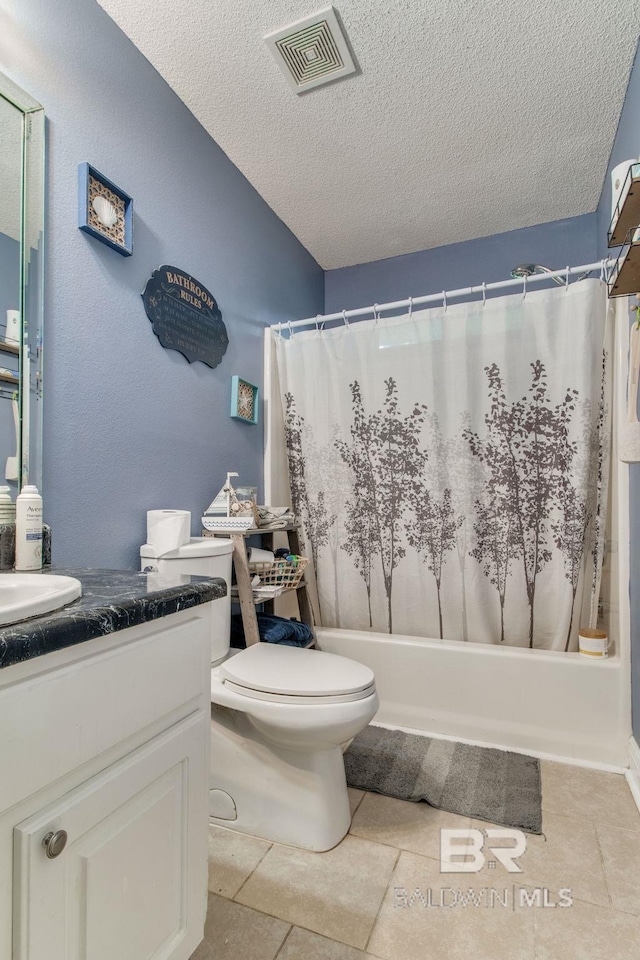 10675 Aloe Ln, Lillian, AL 36549 - full bathroom featuring toilet, a textured ceiling, vanity, shower / bath combo with shower curtain, and tile patterned flooring