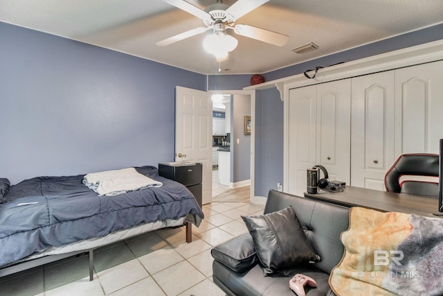 10675 Aloe Ln, Lillian, AL 36549 - bedroom with light tile patterned floors, a closet, a ceiling fan, and an office area
