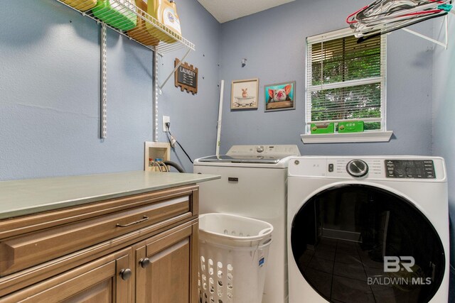 10675 Aloe Ln, Lillian, AL 36549 - washroom with washer and dryer and cabinet space