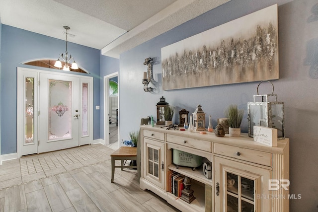 10675 Aloe Ln, Lillian, AL 36549 - foyer featuring a chandelier and baseboards