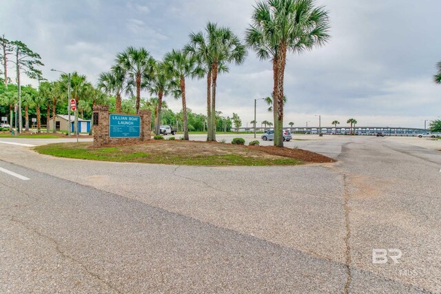 10675 Aloe Ln, Lillian, AL 36549 - view of asphalt road with traffic signs and street lighting