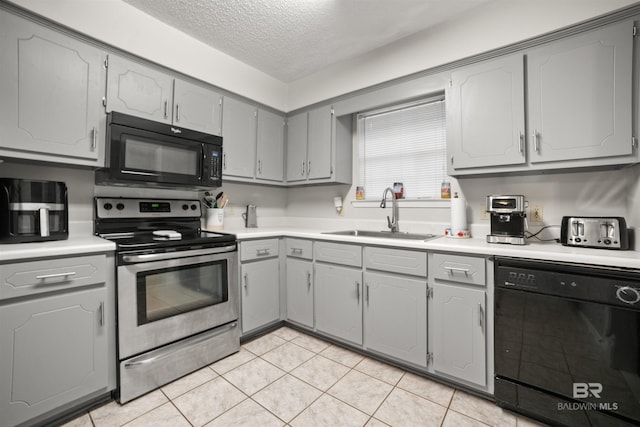 kitchen with gray cabinetry, sink, a textured ceiling, and black appliances