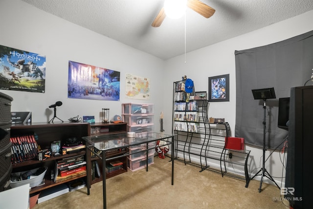 office with ceiling fan, carpet, and a textured ceiling