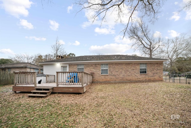 rear view of property with a yard and a deck