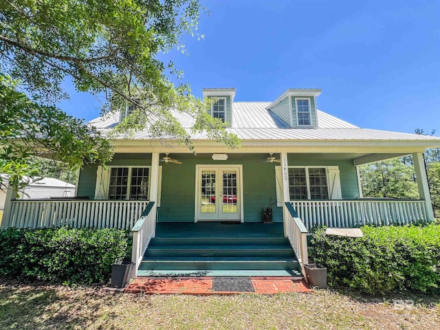 view of front facade with a ceiling fan, covered porch, french doors, and metal roof