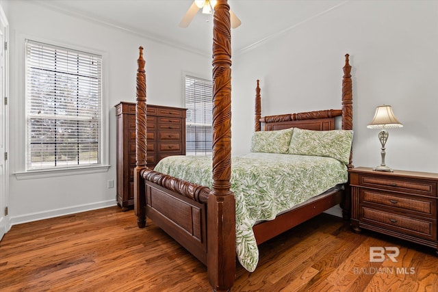 bedroom with ceiling fan, baseboards, wood finished floors, and crown molding