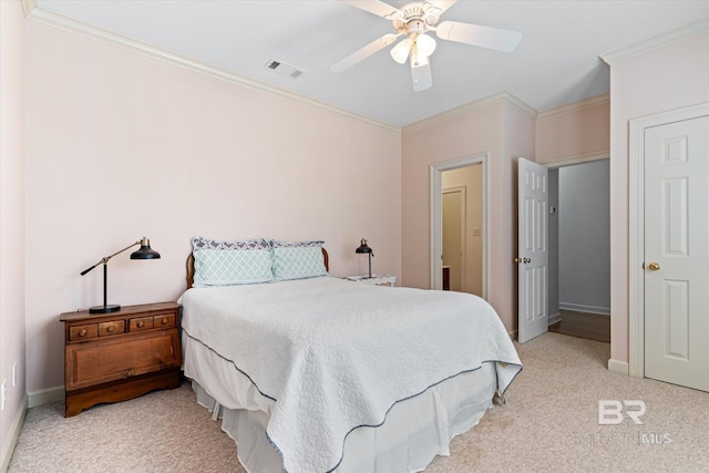 bedroom featuring visible vents, light carpet, baseboards, and ornamental molding