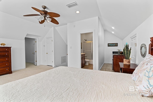 carpeted bedroom with vaulted ceiling, baseboards, and visible vents