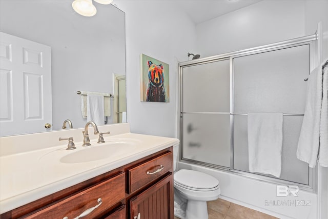 full bathroom featuring tile patterned flooring, toilet, vanity, and enclosed tub / shower combo