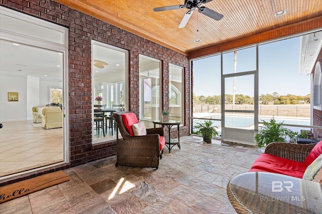 sunroom / solarium featuring wooden ceiling and ceiling fan