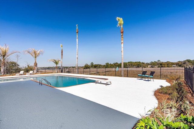 view of swimming pool featuring a diving board, a fenced in pool, fence, and a patio area