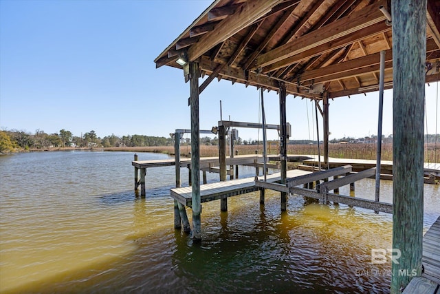 dock area with a water view and boat lift