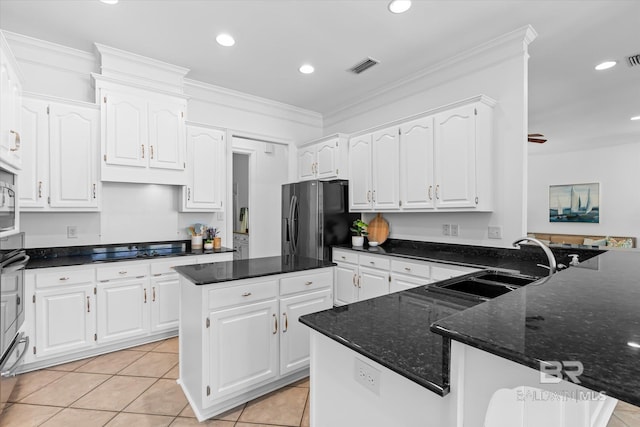 kitchen featuring visible vents, black appliances, a sink, white cabinets, and crown molding