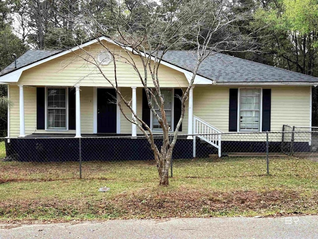 view of front facade with a fenced front yard, a porch, and a shingled roof