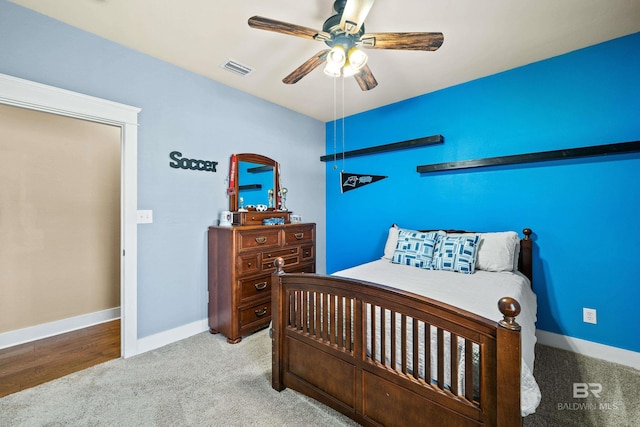 bedroom featuring visible vents, carpet flooring, a ceiling fan, and baseboards