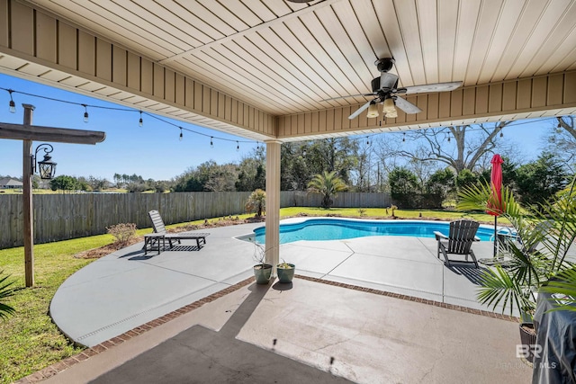 view of pool with a fenced in pool, a lawn, a fenced backyard, a ceiling fan, and a patio