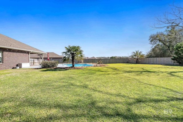 view of yard featuring a patio area, a fenced in pool, and a fenced backyard