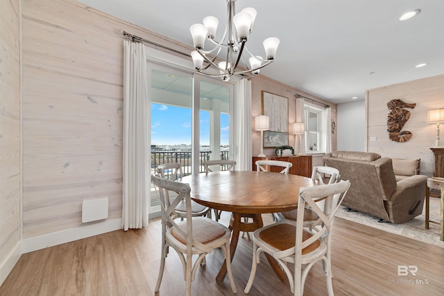 dining area featuring a notable chandelier and light wood-type flooring