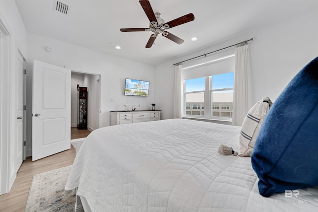 bedroom with ceiling fan and light wood-type flooring