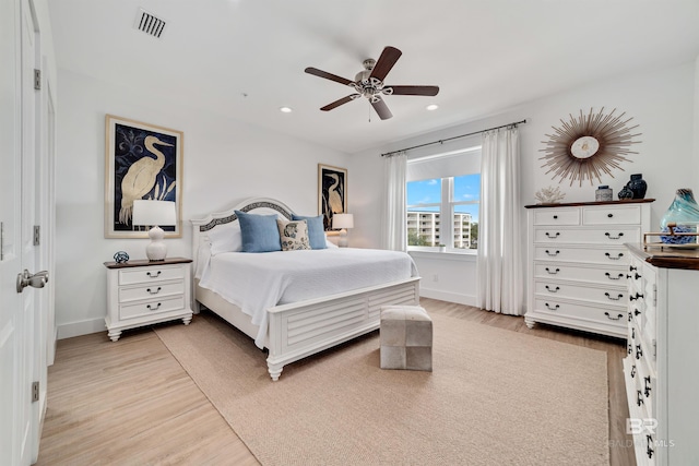 bedroom with ceiling fan and light hardwood / wood-style floors