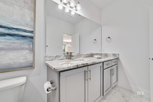 bathroom with tile floors, toilet, and vanity