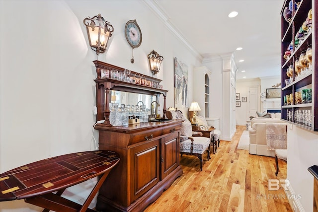 hallway with baseboards, light wood-style floors, recessed lighting, and crown molding