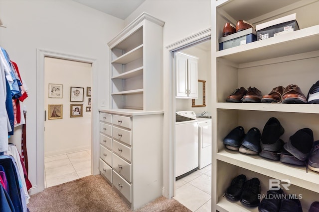 walk in closet featuring light tile patterned floors and independent washer and dryer