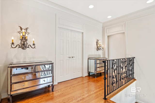 corridor with baseboards, ornamental molding, recessed lighting, and light wood-style floors