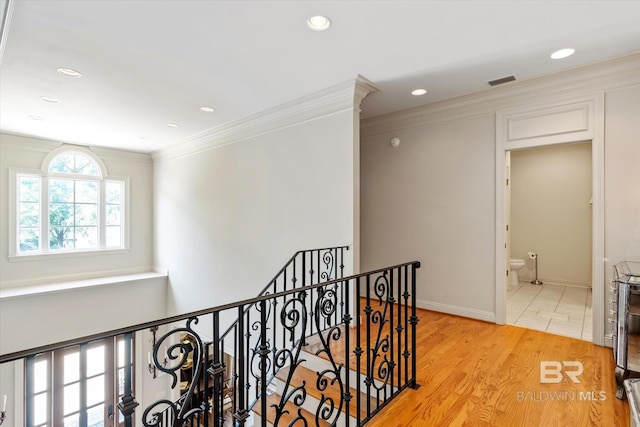 hall featuring light wood finished floors, recessed lighting, an upstairs landing, and crown molding