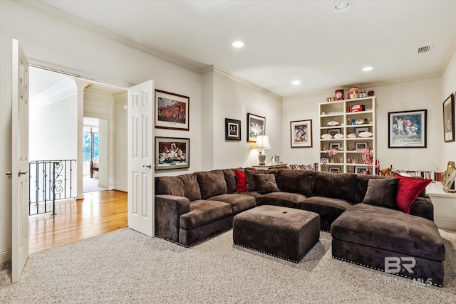 living area with recessed lighting, visible vents, and crown molding