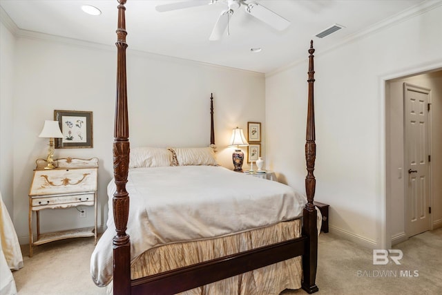 bedroom with visible vents, ornamental molding, baseboards, and light colored carpet