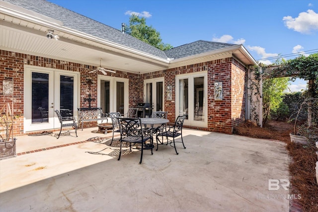 view of patio featuring an outdoor fire pit, a grill, and french doors