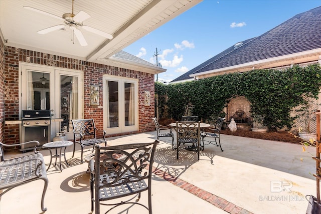 view of patio / terrace featuring french doors, outdoor dining area, ceiling fan, a grill, and an outdoor fireplace