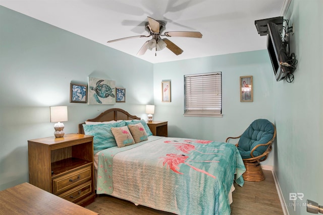 bedroom with dark hardwood / wood-style floors and ceiling fan