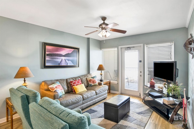 living room featuring ceiling fan and light hardwood / wood-style flooring