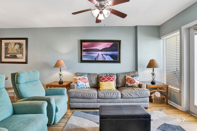 living room featuring ceiling fan and light wood-type flooring