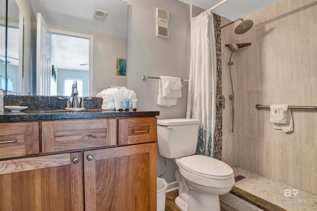 bathroom with toilet, curtained shower, vanity, and hardwood / wood-style flooring