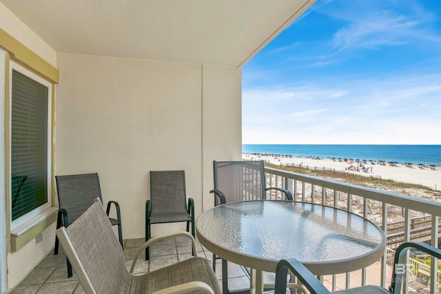 balcony featuring a water view and a beach view