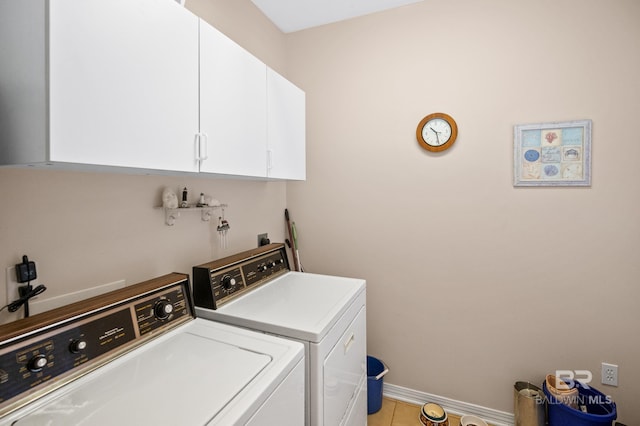 washroom featuring cabinets, washer and dryer, and tile patterned floors