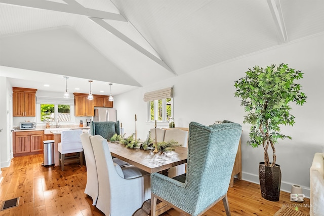 dining room with light wood-style flooring, vaulted ceiling, baseboards, and recessed lighting