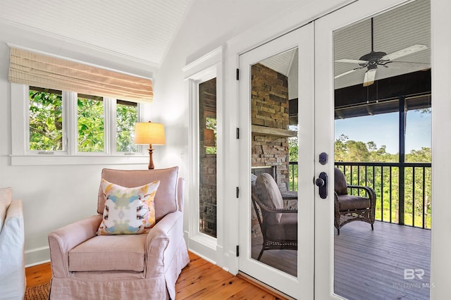 sunroom / solarium featuring french doors and lofted ceiling